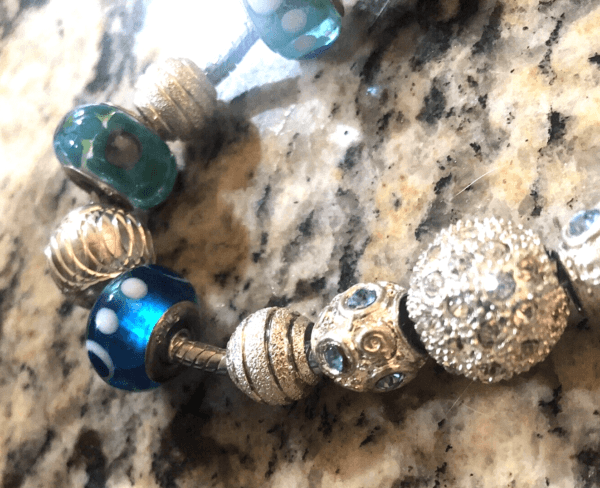pandora bracelet with blue and silver beads close up