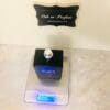 black one black for men eau de toilette spray on scale