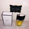 Oscar by Oscar de la Renta perfume, next to box, in front of Ode to Parfum sign, pictured from the top