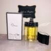 Oscar by Oscar de la Renta perfume, next to box with cap off, in front of Ode to Parfum sign,