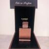 amber oud tobacco edition eau de parfum standing in velvet-lined box, with copper side showing
