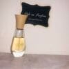 Maurices Sungari perfume, original formula, 1 oz bottle next to Ode to Parfum sign