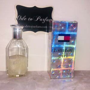 tommy girl shimmering body mist by tommy hilfiger, next to holographic box