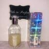 tommy girl shimmering body mist by tommy hilfiger, next to holographic box