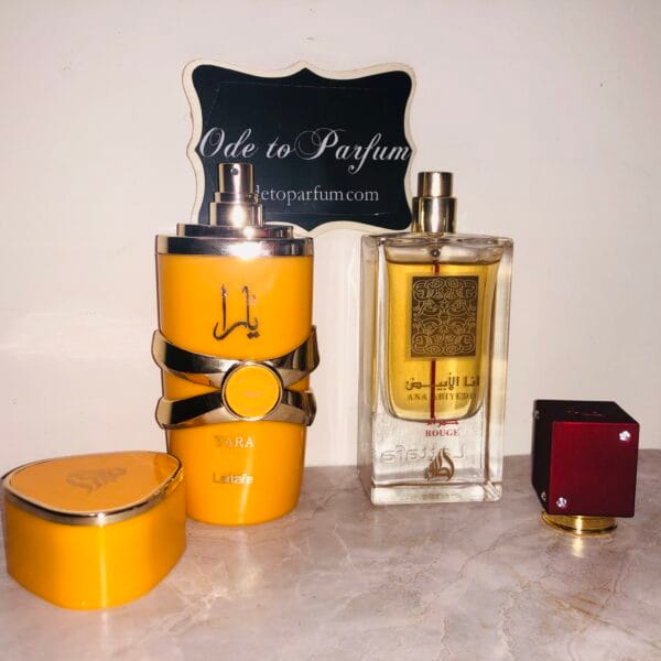 Lattafa Yara Tous & Ana Abiyedh Rouge perfumes in front of Ode to Parfum sign